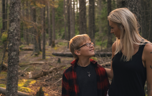 Cassie Bailey and her son outdoors in the woods