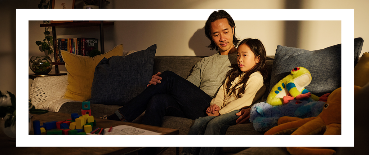 A father and his daughter sitting on a couch